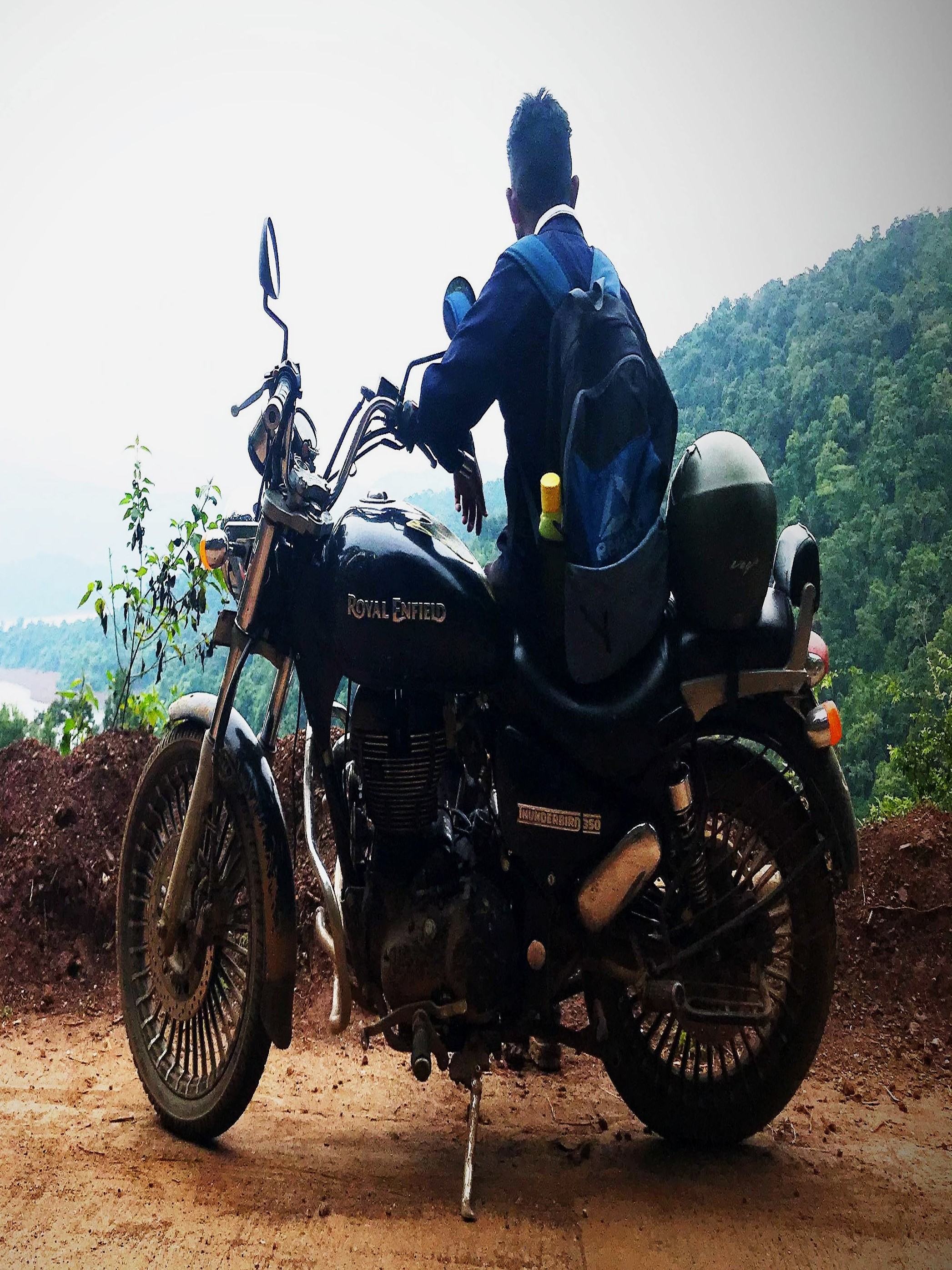 Scenic view of the Western Ghats landscape with dense forests and winding roads leading to Sathodi Falls