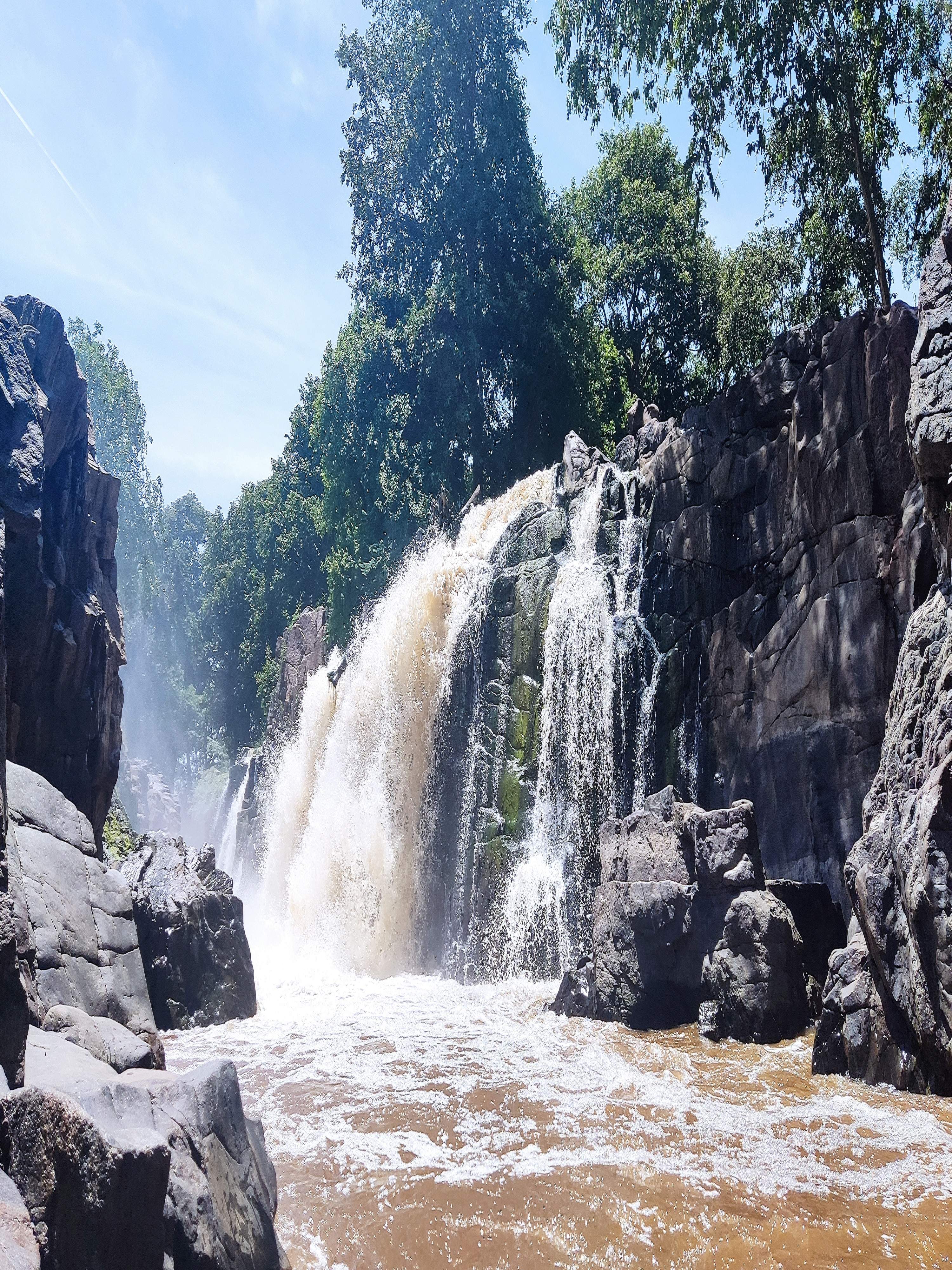 Close-up of Hogenekkal Falls with water crashing down creating a misty and dramatic scene