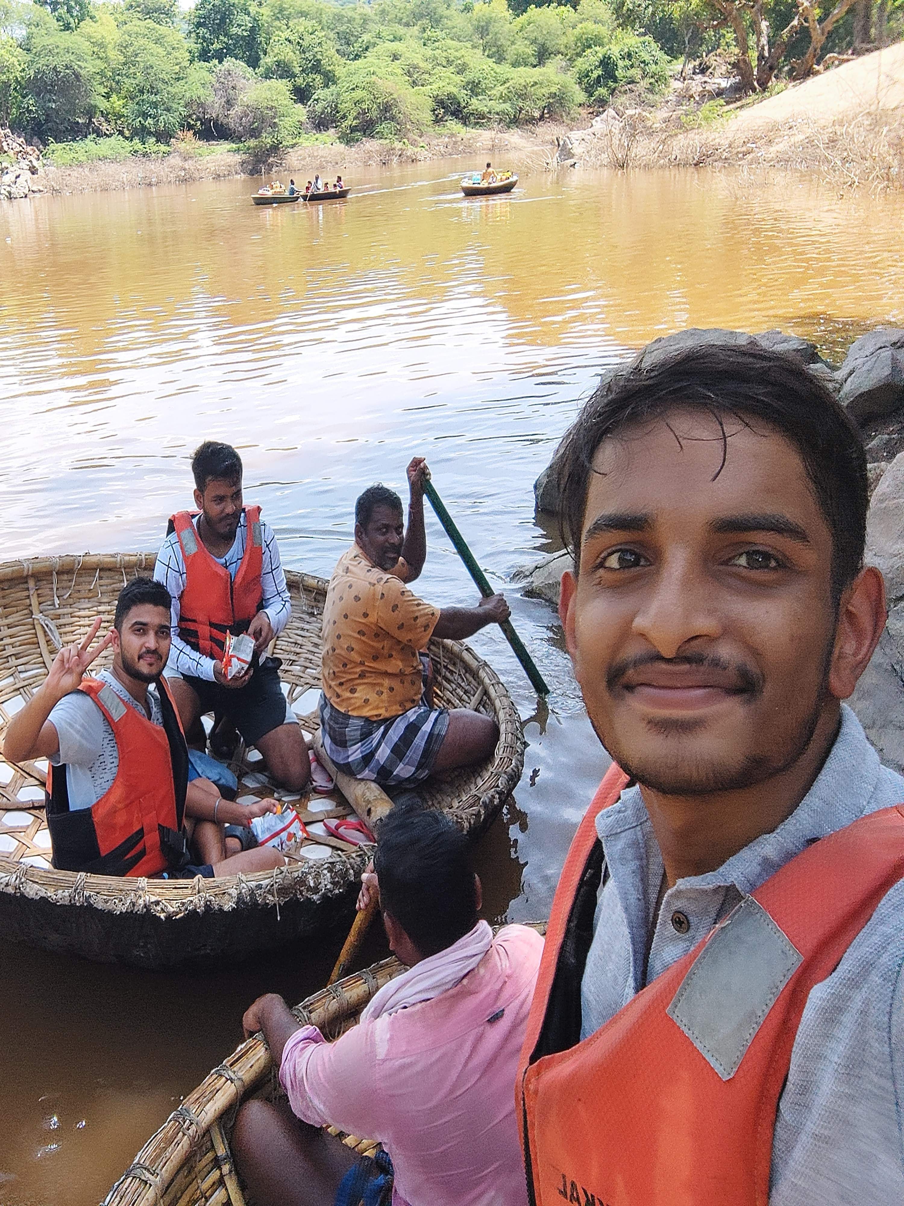 Traditional coracle boat ride on the river approaching Hogenekkal Falls for an up-close view