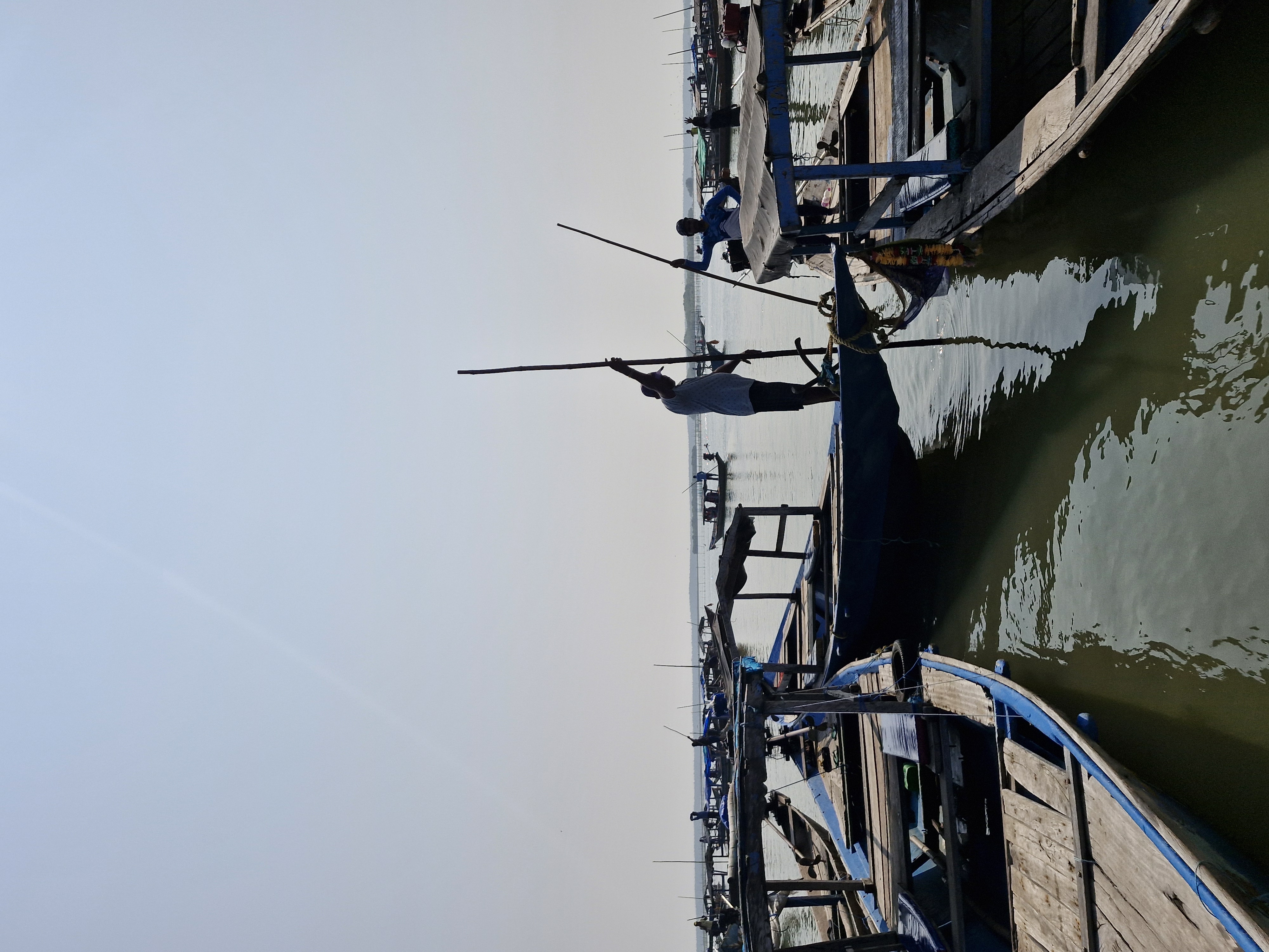 Scenic boat ride on Chilika Lake with seagulls flying alongside and distant islands