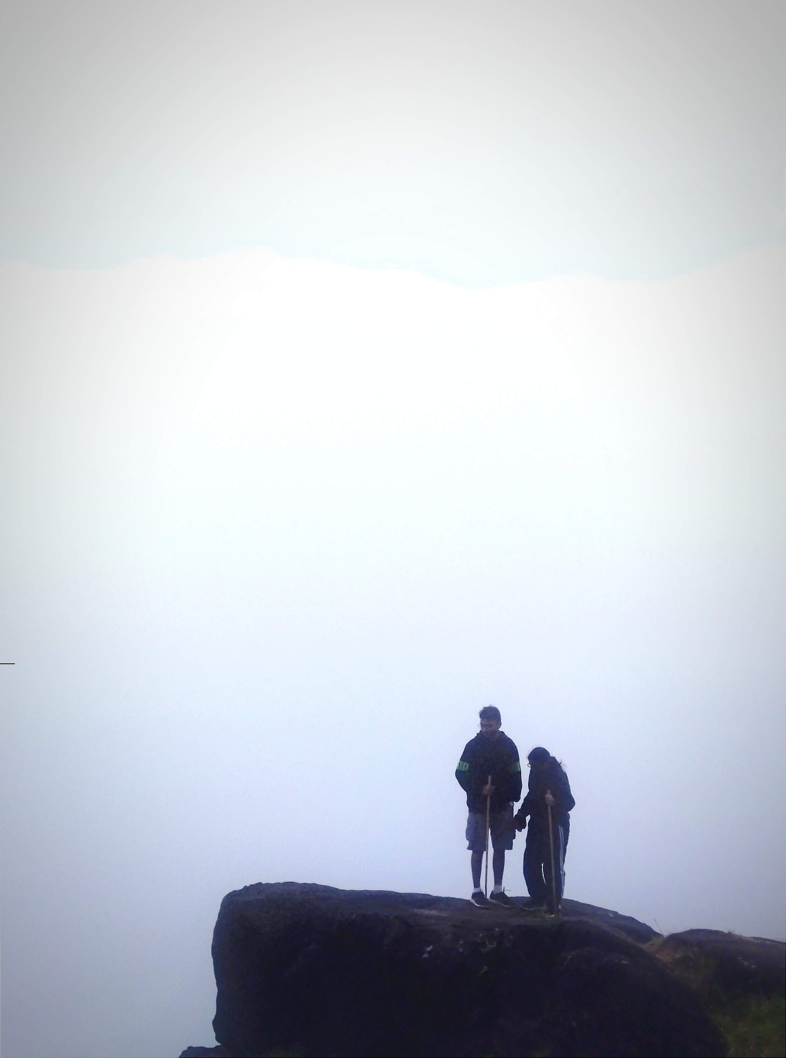 Summit of Kumara Parvatha with Shiva temple and trekkers celebrating